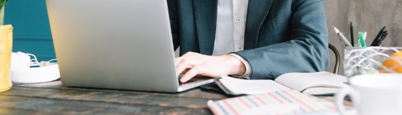 person in an office typing on the computer